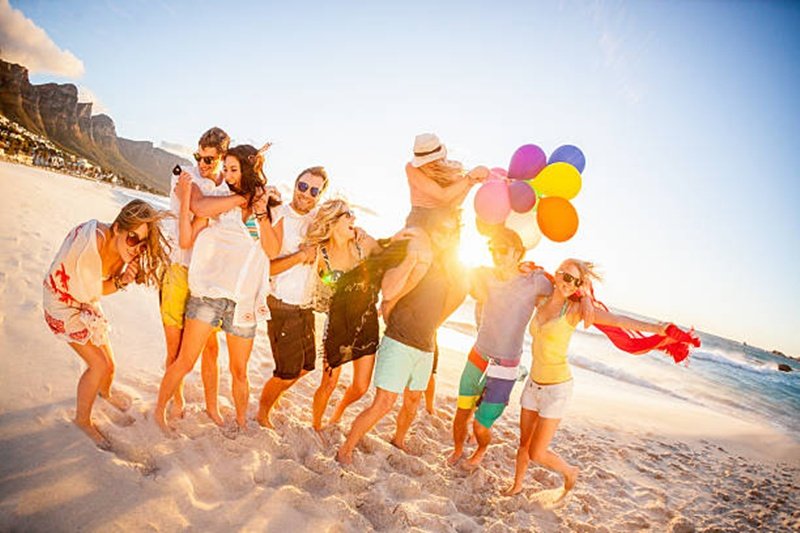Young fun party people having fun on the beach with balloons. Pls checkout our lightboxes for further images